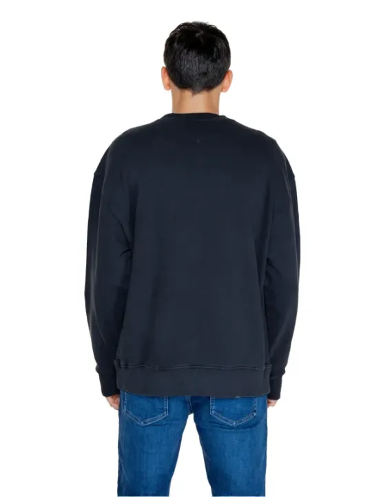 Schwarzer Pullover, blaue Jeans getragen