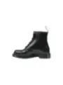 Glänzende schwarze Dr. Martens Stiefel